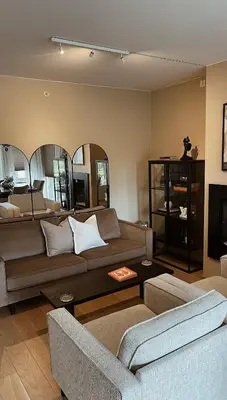 a living room with a couch and a table at Stylish home near airport in Bergen