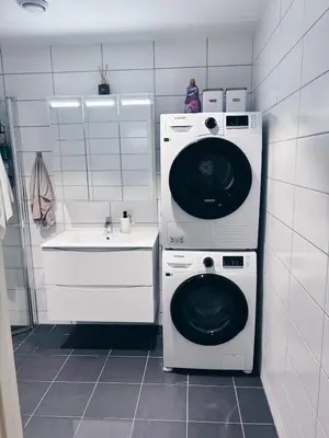 a laundry room with a washing machine and a sink at Stylish home near airport in Bergen