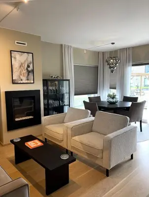 a living room with a couch and chairs and a table at Stylish home near airport in Bergen