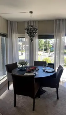a dining room with a table and chairs and a chandelier at Stylish home near airport in Bergen