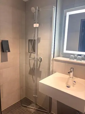 a bathroom with a shower and a sink at Thon Hotel Verdal in Verdal