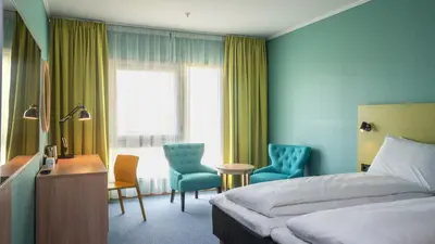 a hotel room with a bed and a desk and chairs at Thon Hotel Verdal in Verdal