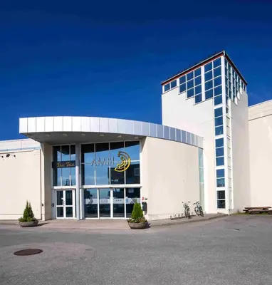 a large white building with a sign on it at Thon Hotel Verdal in Verdal