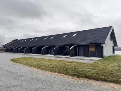 a black and white building with solar panels on it at Moderne leilighet på Glomsrud Golsfjellet vest in Gol