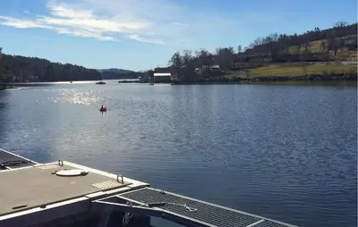 a boat in a large body of water at Cozy Home In Førde I Hordaland in Erve