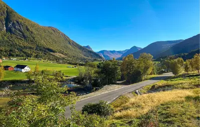 a road in a valley with mountains in the background at Beautiful Home In Vistdal With Wifi in Myklebostad