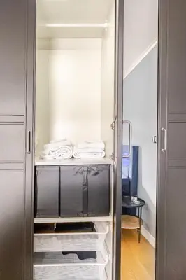 a walk in closet with towels on the shelves at Beautiful 2-bedroom apartment in Bergen