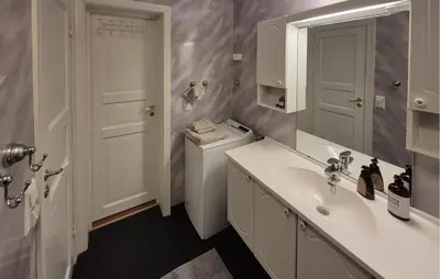 a bathroom with a sink and a washing machine at Awesome Apartment In Trysil With Sauna in Trysil