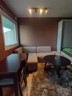a living room with a couch and a table at Cozy Studio in Hallset, Trondheim in Trondheim