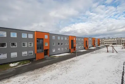 a row of apartment buildings with orange and gray at Cozy Studio in Hallset, Trondheim in Trondheim