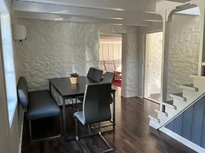 a dining room with a table and chairs at Grey Lodge in Isfjorden