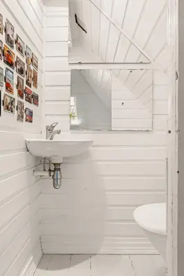 a white bathroom with a sink and a toilet at The 1880 Authentic Bergen Dream I 500m to Bryggen in Bergen