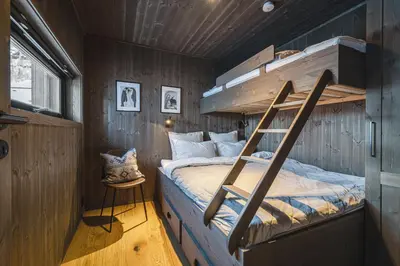 a bedroom with a bunk bed with a ladder at Hemsedal ski in ski out, modern comfort by the slopes in Hemsedal