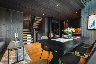 a dining room with a black table and chairs at Hemsedal ski in ski out, modern comfort by the slopes in Hemsedal