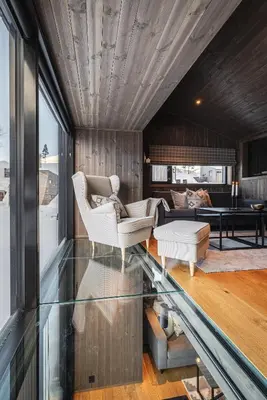 a living room with two chairs and a couch at Hemsedal ski in ski out, modern comfort by the slopes in Hemsedal