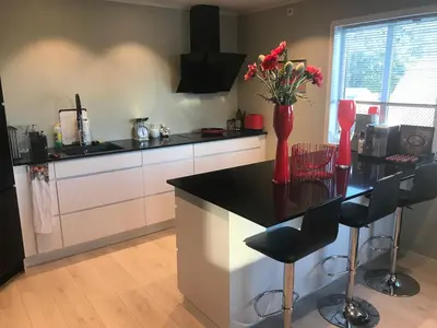a kitchen with a counter with a vase of flowers on it at Townhouse with 4 bedrooms near Sørstrand