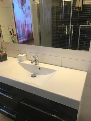 a bathroom with a white sink and a mirror at Townhouse with 4 bedrooms near Sørstrand