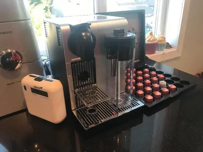 a coffee maker sitting on top of a counter with cupcakes at Townhouse with 4 bedrooms near Sørstrand