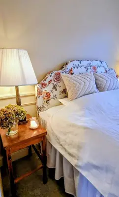 a bedroom with a bed and a table with a lamp at Rent your own Boutiqe hotel in Skammestein