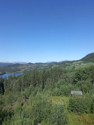 a view of a lake from a hill with a house at Rent your own Boutiqe hotel in Skammestein