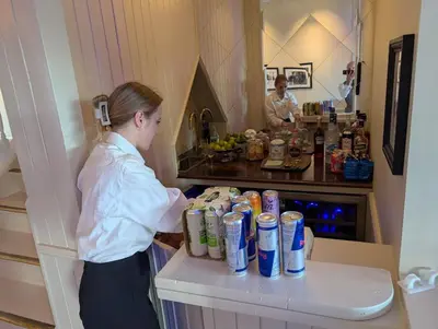 a woman standing in front of a counter with drinks at Rent your own Boutiqe hotel in Skammestein