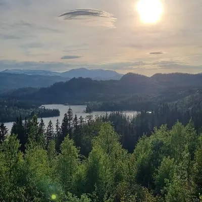 a view of a lake with the sun in the sky at Rent your own Boutiqe hotel in Skammestein