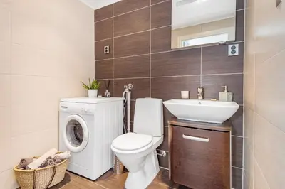 a bathroom with a washing machine and a sink at Charming in the center of Hamar in Hamar