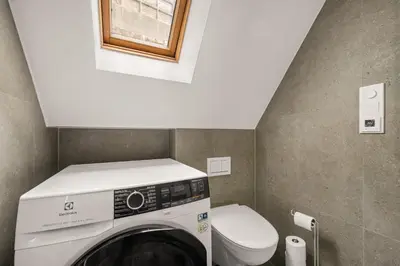 a washing machine in a bathroom with a toilet at Bergen Villa - Charming 3 Bedroom with Views! in Bergen
