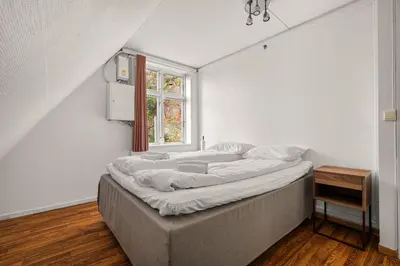 two beds in a room with a window at Bergen Villa - Charming 3 Bedroom with Views! in Bergen