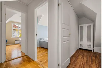 a hallway with a door and a bed in a room at Bergen Villa - Charming 3 Bedroom with Views! in Bergen