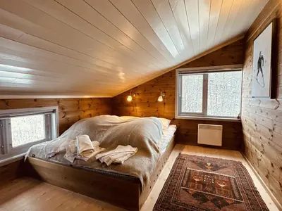 a bedroom with a bed in a wooden room at Familiehytte med fantastisk beliggenhet i Vestlia in Geilo