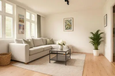 a living room with a white couch and a table at Twin Flat 2nd Floor Bergen Centre - Norwegians minimum age 25 in Bergen
