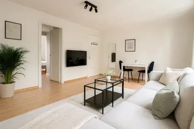 a living room with a white couch and a table at Twin Flat 2nd Floor Bergen Centre - Norwegians minimum age 25 in Bergen