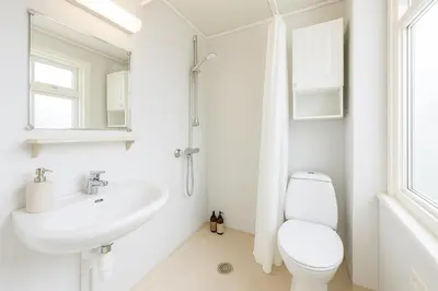 a white bathroom with a toilet and a sink at Twin Flat 2nd Floor Bergen Centre - Norwegians minimum age 25 in Bergen