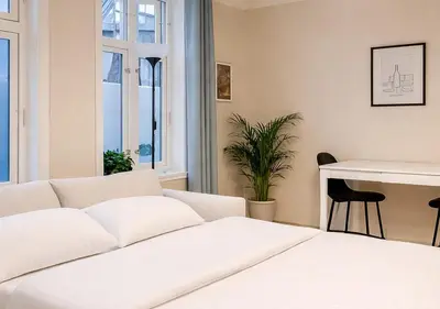 a white bed in a room with a desk at Twin Flat 2nd Floor Bergen Centre - Norwegians minimum age 25 in Bergen