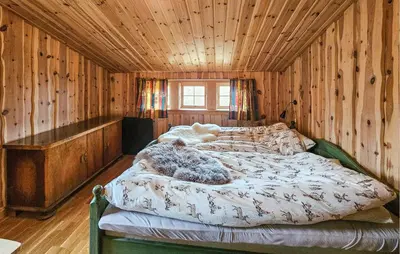 a bedroom with a bed in a wooden room at 4 Bedroom Gorgeous Home In Rjukan in Rjukan
