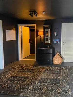a living room with a yellow door and a rug at Panoramic Apartment In The Heart Of Beitostølen in Beitostøl
