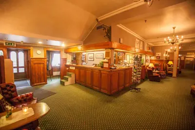 a large room with a bar in the center of a building at Fleischer's Motel in Vossevangen