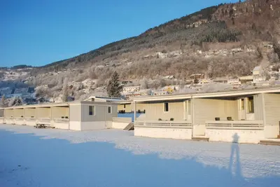 a row of buildings with snow on the ground at Fleischer's Motel in Vossevangen