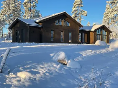 a house covered in snow in front of a yard at Trysilfjell hytteområde 2115 by Vacation Trysil in Trysil