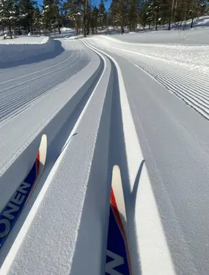 a pair of skis in the snow on a road at Cozy family cabin at Hovden in Bykle