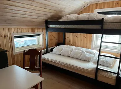 a bedroom with two bunk beds in a cabin at Cozy family cabin at Hovden in Bykle