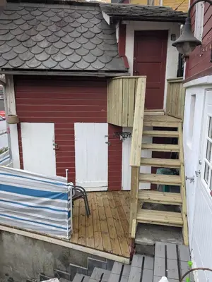 a house with a staircase leading up to a garage at Cozy bedroom & basement with amenities in Odda