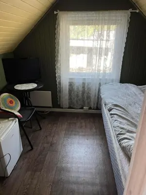 a bedroom with a bed and a window and a desk at Cozy bedroom & basement with amenities in Odda