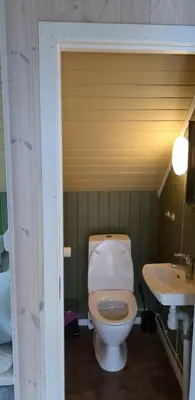 a bathroom with a toilet and a sink at Cozy bedroom & basement with amenities in Odda