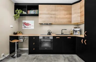a kitchen with black cabinets and a counter at Trondheim's smallest detached house in the middle of the city centre! in Trondheim