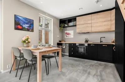 a kitchen with a wooden table and chairs at Trondheim's smallest detached house in the middle of the city centre! in Trondheim