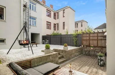 a backyard with a fire pit in a house at Trondheim's smallest detached house in the middle of the city centre! in Trondheim