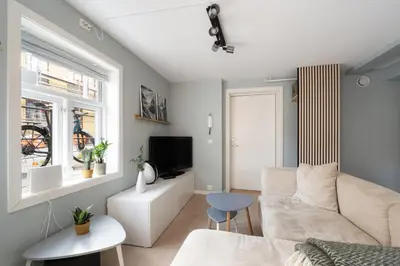 a living room with a couch and a tv at Central apartement in Kristiansund in Kristiansund