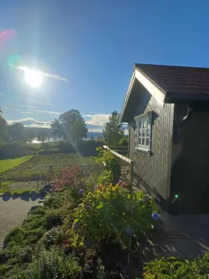 a house with a garden with the sun in the background at Lovely tiny house with a dream view !